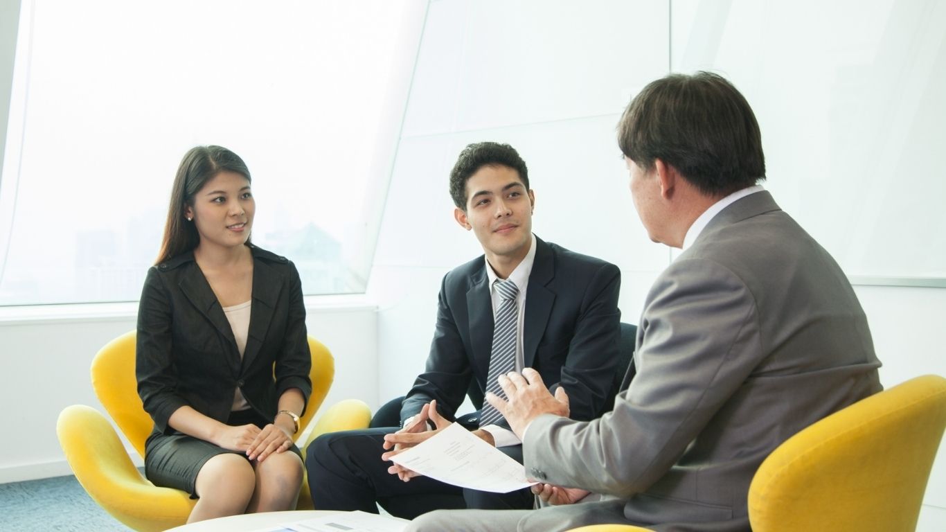 Business owner consulting with a New York attorney about legal strategy in a professional office setting
